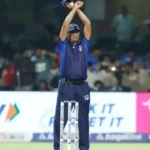 An umpire signalling the arrival of an Impact Player