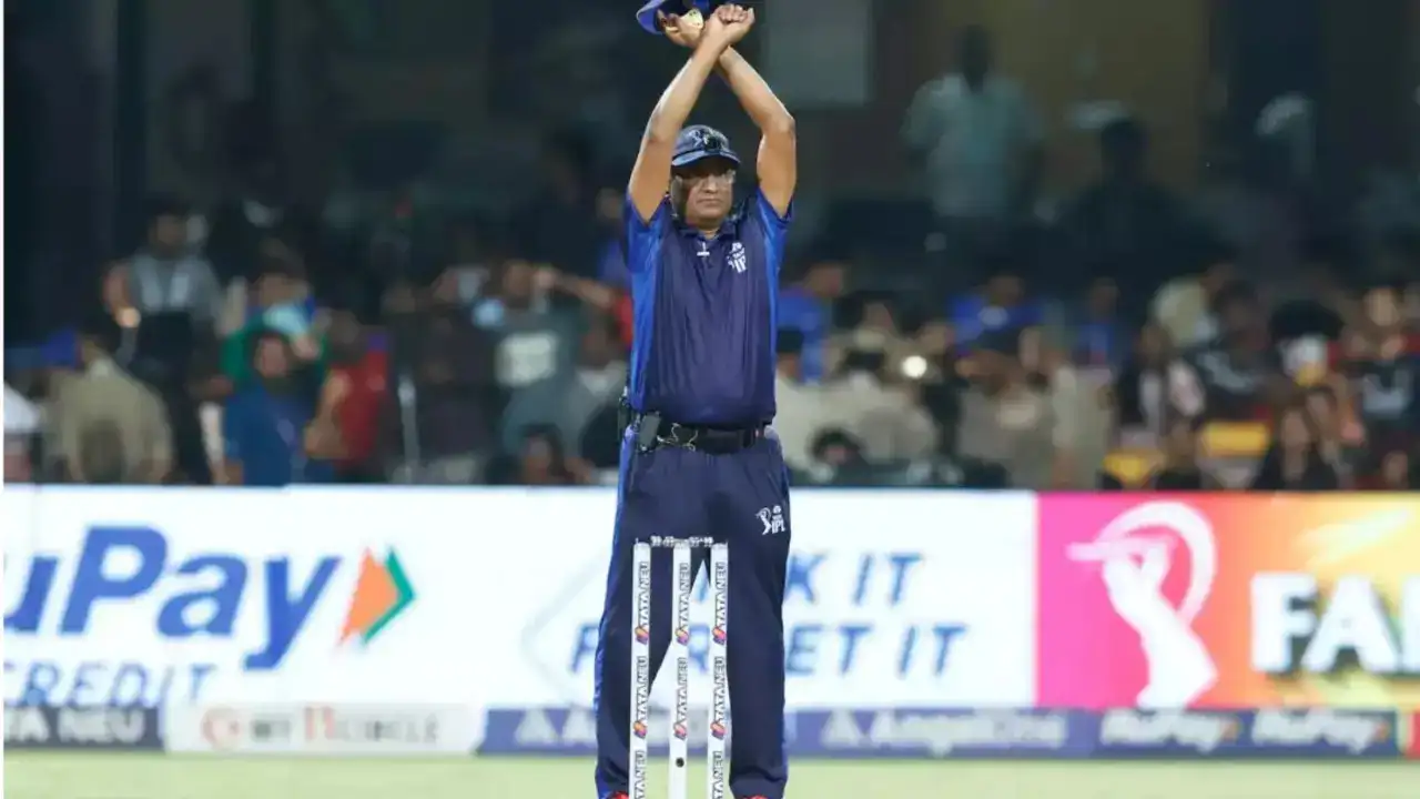 An umpire signalling the arrival of an Impact Player